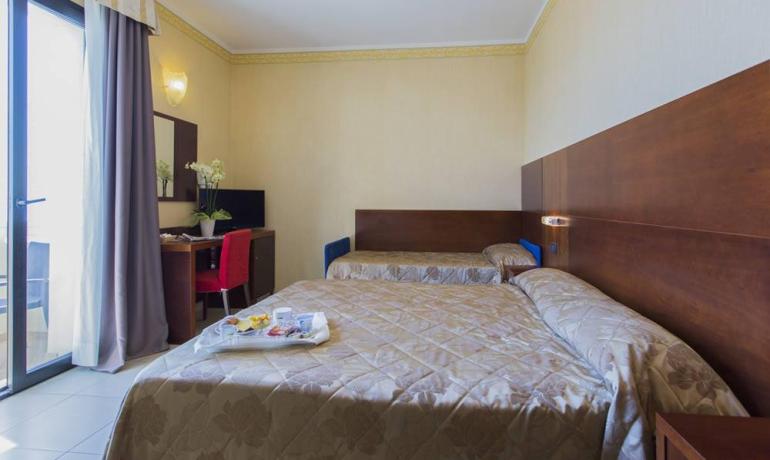 Bright room with cozy beds and breakfast served, welcoming and relaxing atmosphere.