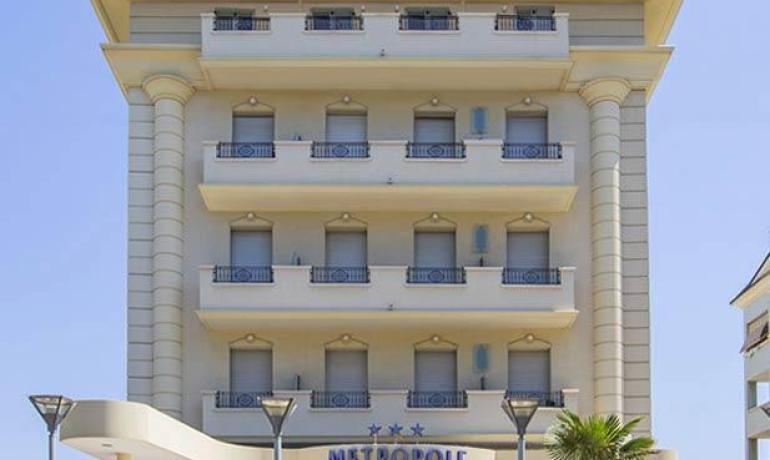 Elegant hotel with balconies, summer vibe, welcoming atmosphere.